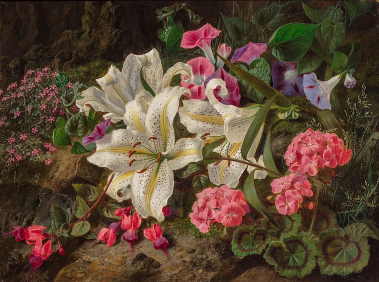 White lilies and pink flowers with green foliage arranged in a lush garden setting.