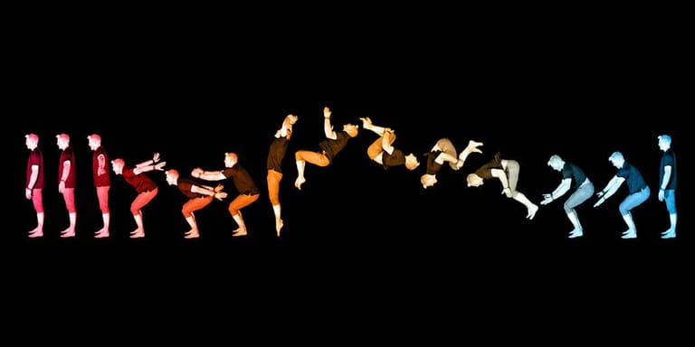 Silhouetted figures in gradient colours from red to blue performing dynamic dancing poses against black background.