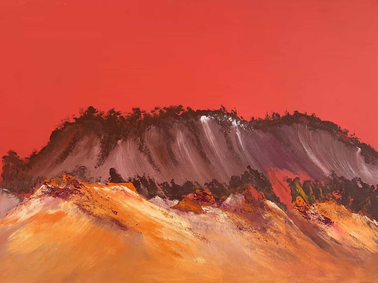 Volcanic mountain with layered orange and red slopes against a crimson sky.