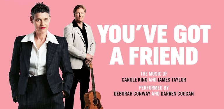 Two performers in formal black and white attire stand against a pink background with "YOU'VE GOT A FRIEND" text.
