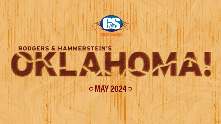 Rodgers & Hammerstein's Oklahoma! title card on wooden background, May 2024.