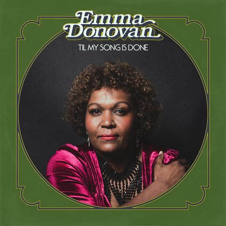 Emma Donovan portrait in bright pink velvet jacket against green album cover for "Til My Song Is Done".