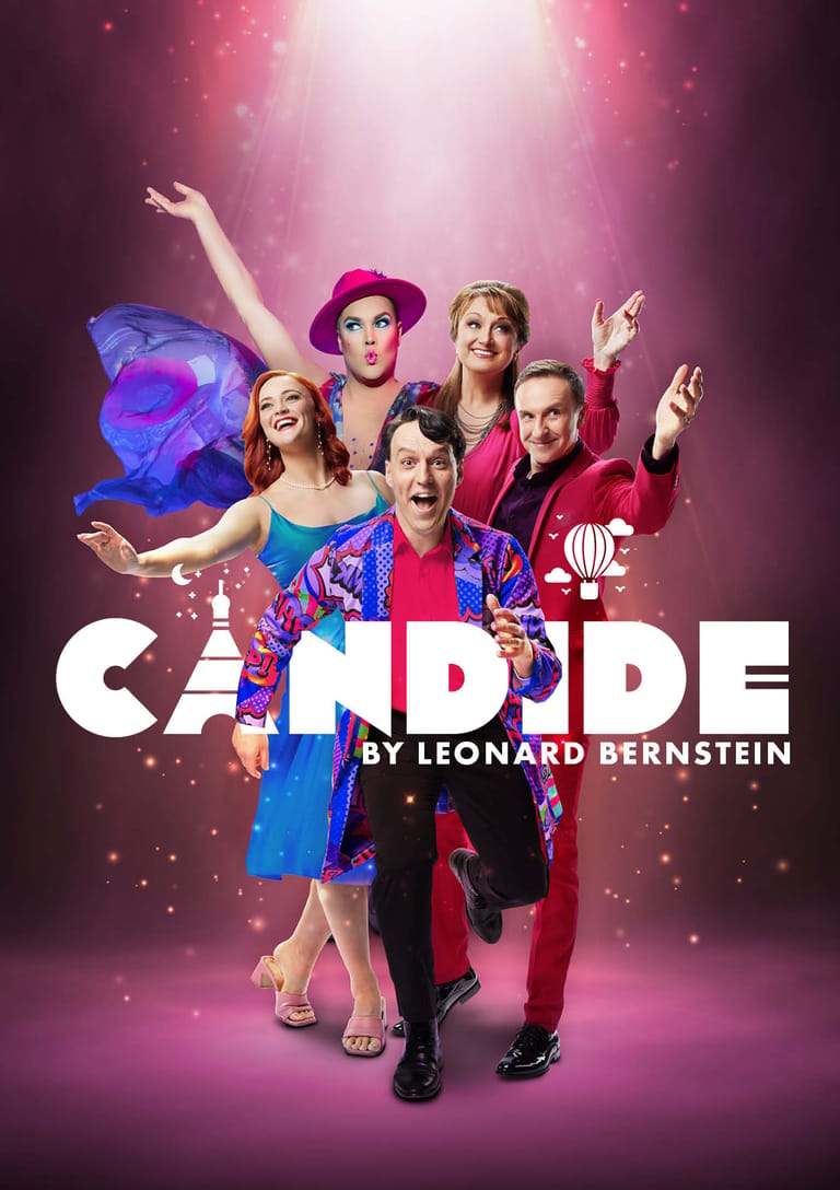 Six performers in colourful costumes strike jubilant poses against a pink-lit stage backdrop for Candide by Leonard Bernstein.