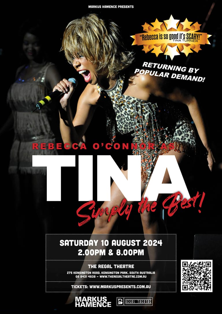 Performer in a sequinned black outfit singing into a microphone on stage under warm spotlights.