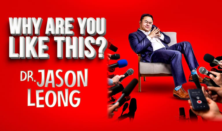 Dr. Jason Leong sits on a red chair against a bright red background, surrounded by scattered shoes.