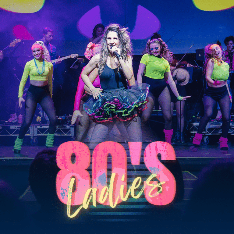 Lead performer in black dress centre stage surrounded by dancers in neon-trimmed outfits during an '80s-themed stage production.