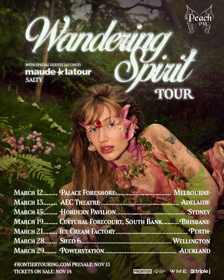 Performer with long hair and pink face paint surrounded by foliage promotes the Wandering Spirit tour across Australian venues.