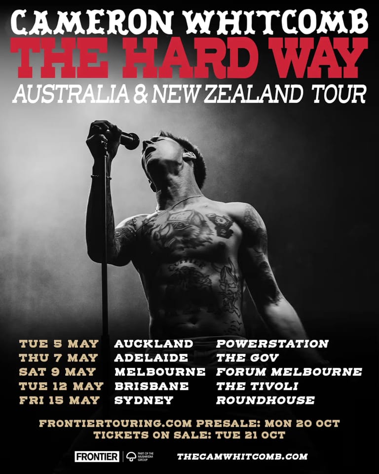 Shirtless male performer holding microphone aloft against dark background, tour dates listed below.