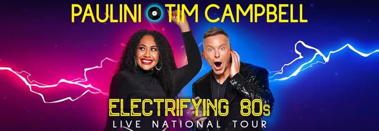 Paulini and Tim Campbell grinning at the camera against a neon-lit purple and blue backdrop with lightning effects for their Electrifying 80s live tour.