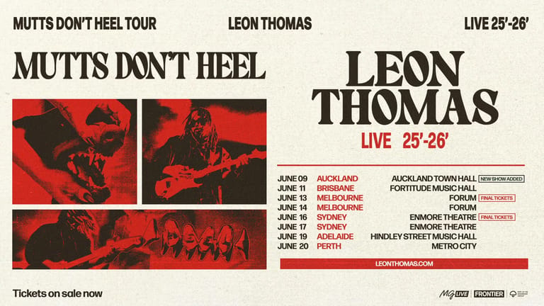 Leon Thomas performs live on stage with red atmospheric lighting during his 25-28 tour dates.