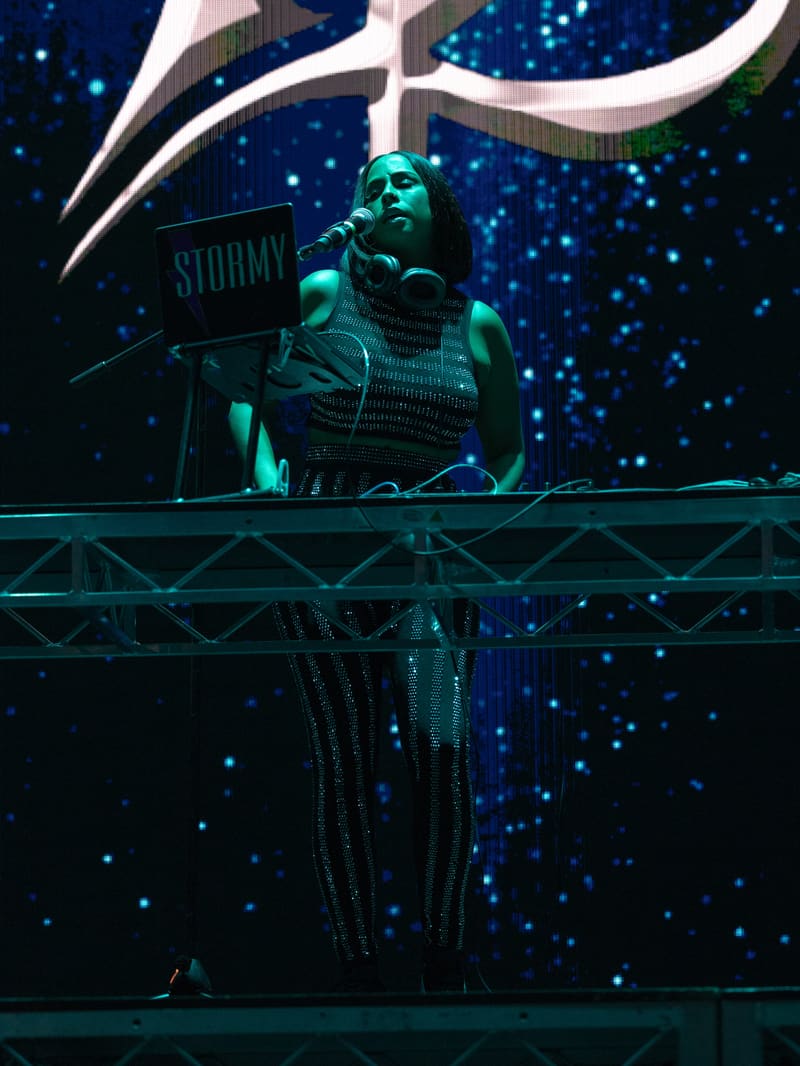 Musician performing at keyboard on stage under turquoise lighting with starlit backdrop at 112 – Fridayz Live.