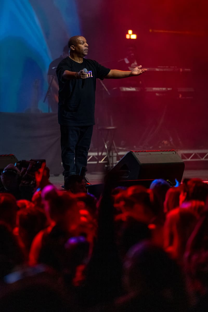 Performer on stage addressing an engaged crowd under red and blue stage lighting at Illtown Sluggaz – Fridayz Live.