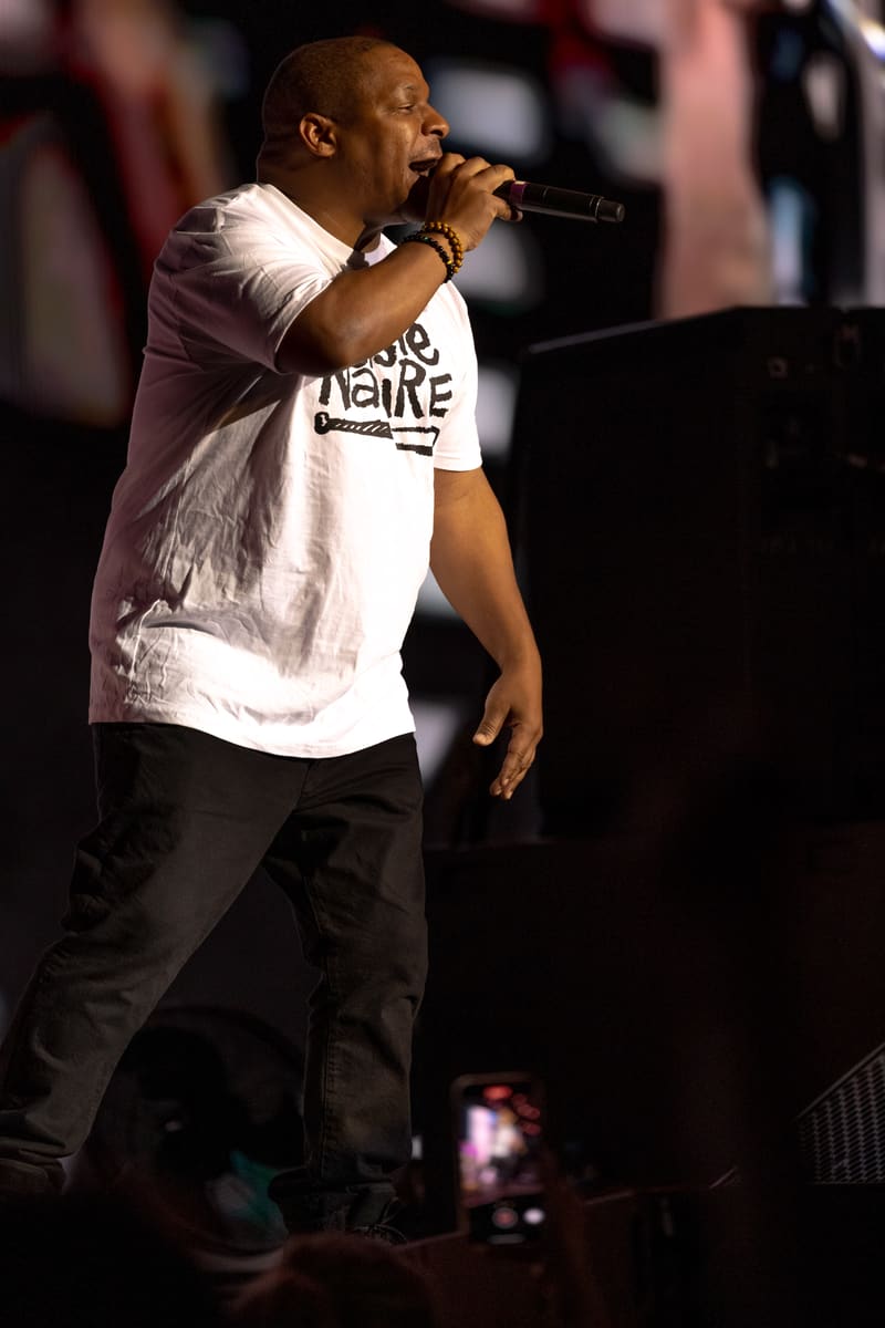 Performer rapping into microphone during Illtown Sluggaz – Fridayz Live stage show.