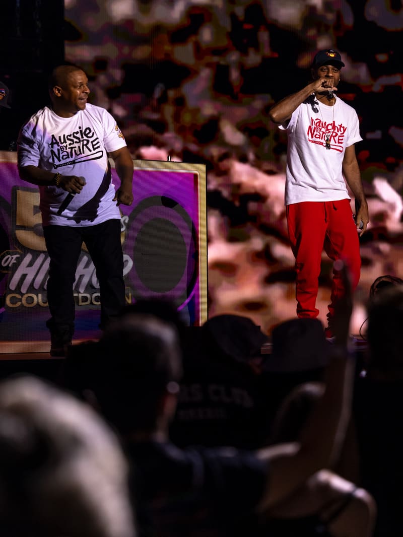 Two performers on stage during Illtown Sluggaz – Fridayz Live, with audience members visible in the foreground.