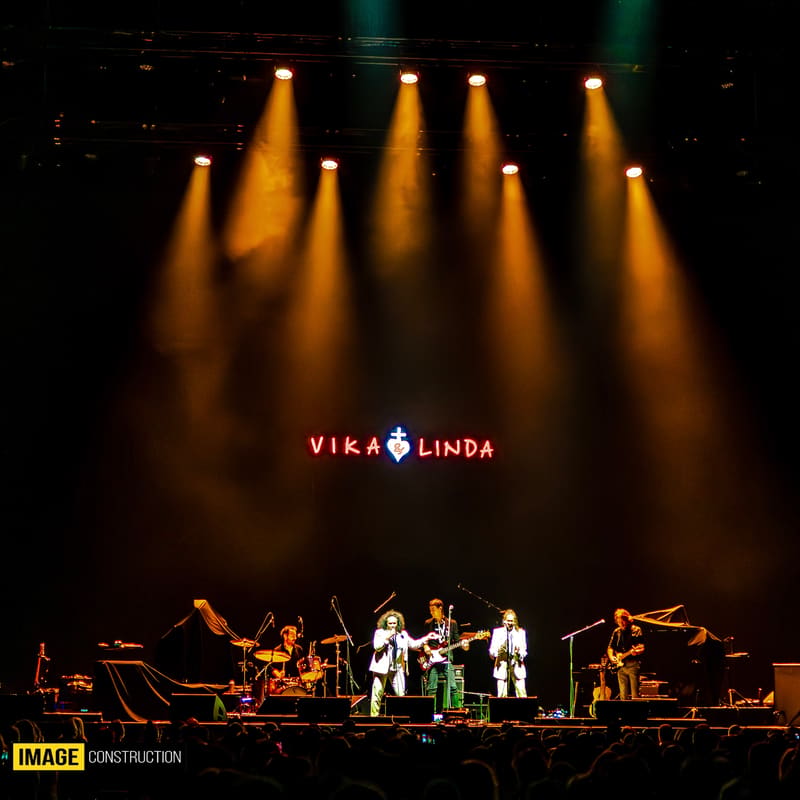 Vika & Linda perform on stage beneath warm golden spotlights during their Forever Enz 2026 tour.